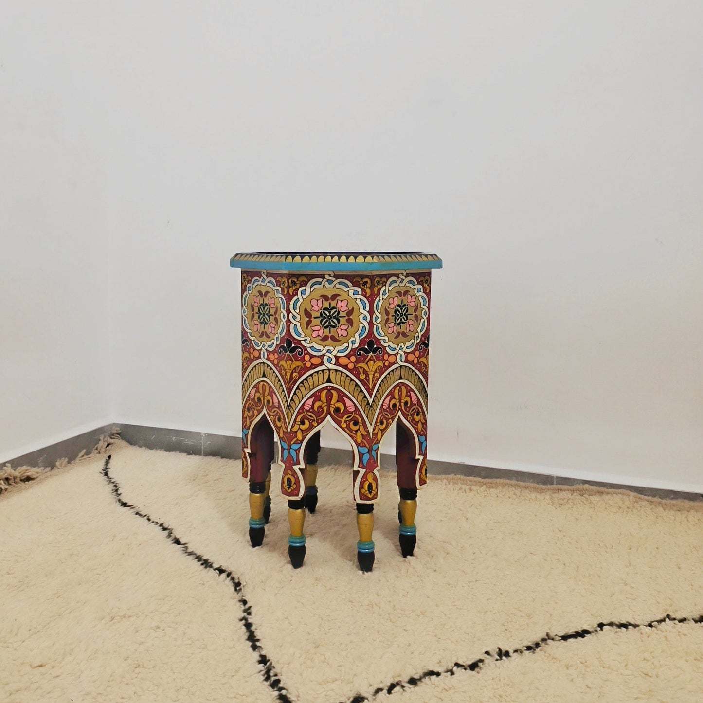 Moroccan hand-printed wooden table with bold Moorish patterns