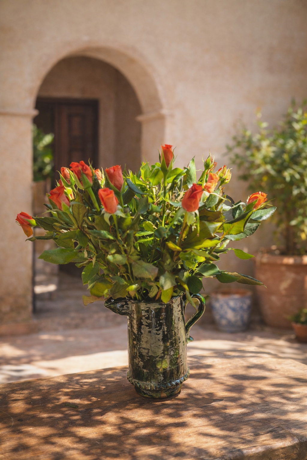 Green handmade Tamegroute pottery vase styled in a Moroccan home interior