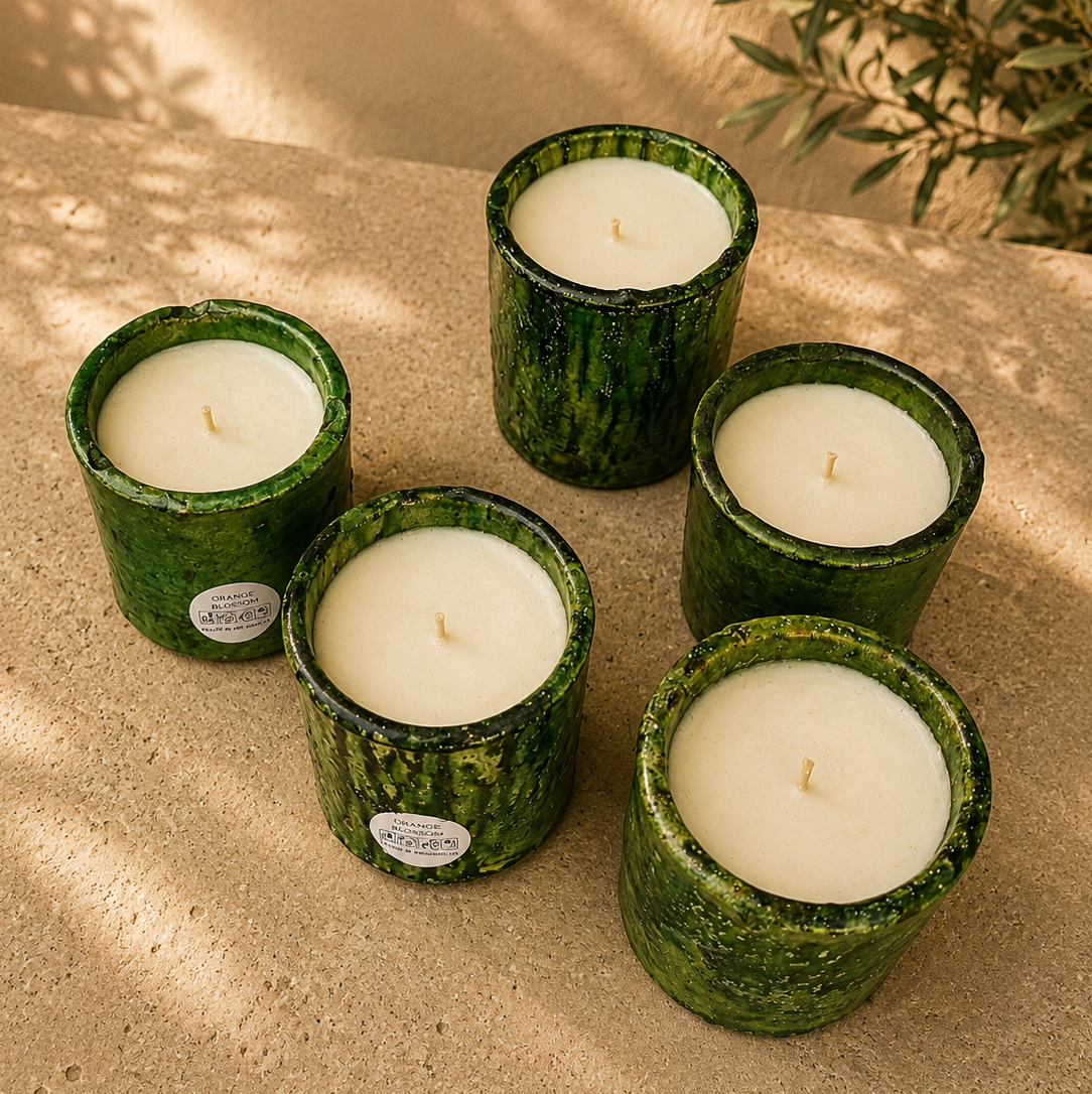 Collection of handmade green Tamegroute ceramic candles filled with natural orange blossom scented soy wax.