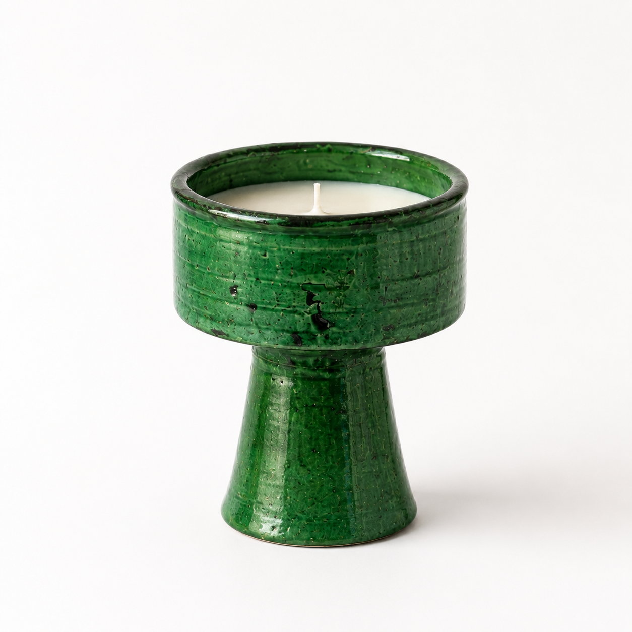 Handmade Tamegroute ceramic candle in authentic green Moroccan pottery displayed on a coffee table