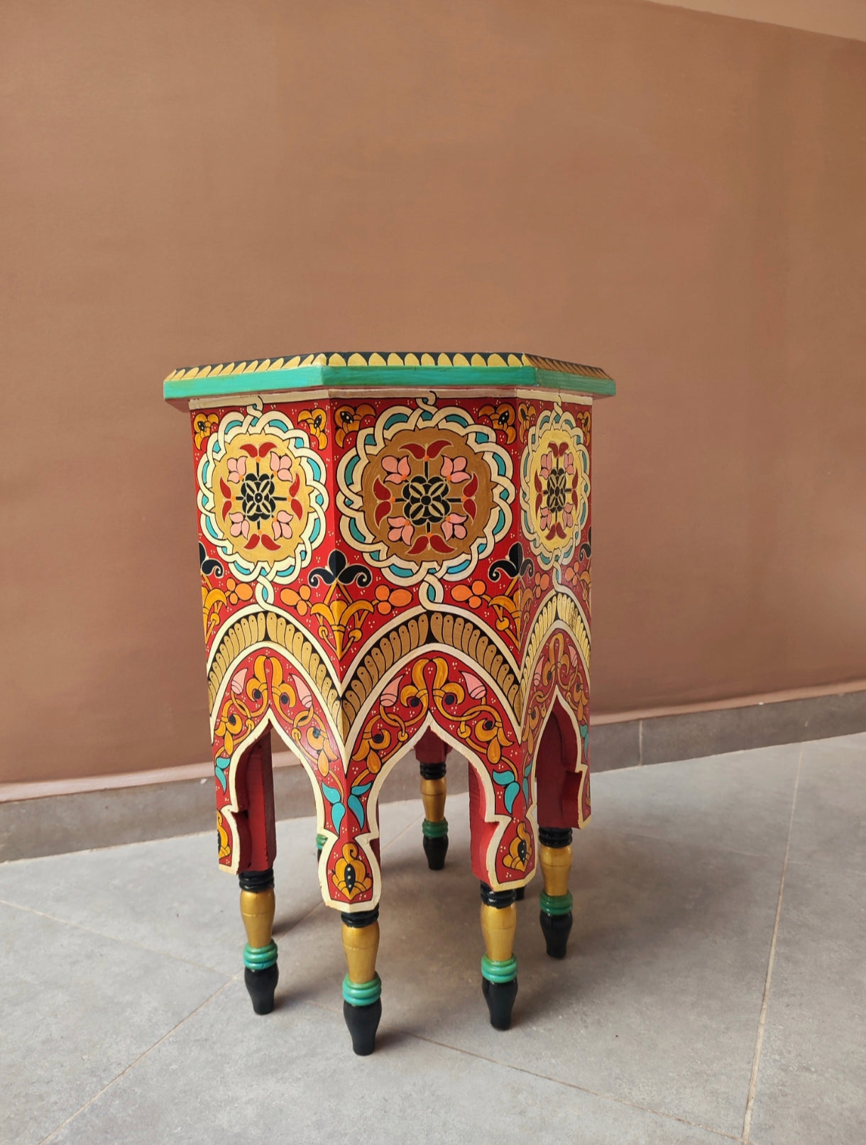 Royal style hand-printed wooden table with bold Moorish patterns 