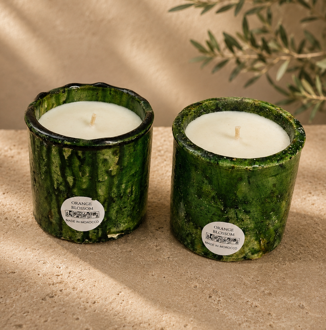 A pair of green textured hand-poured candles highlighting the unique artisan jar patterns.