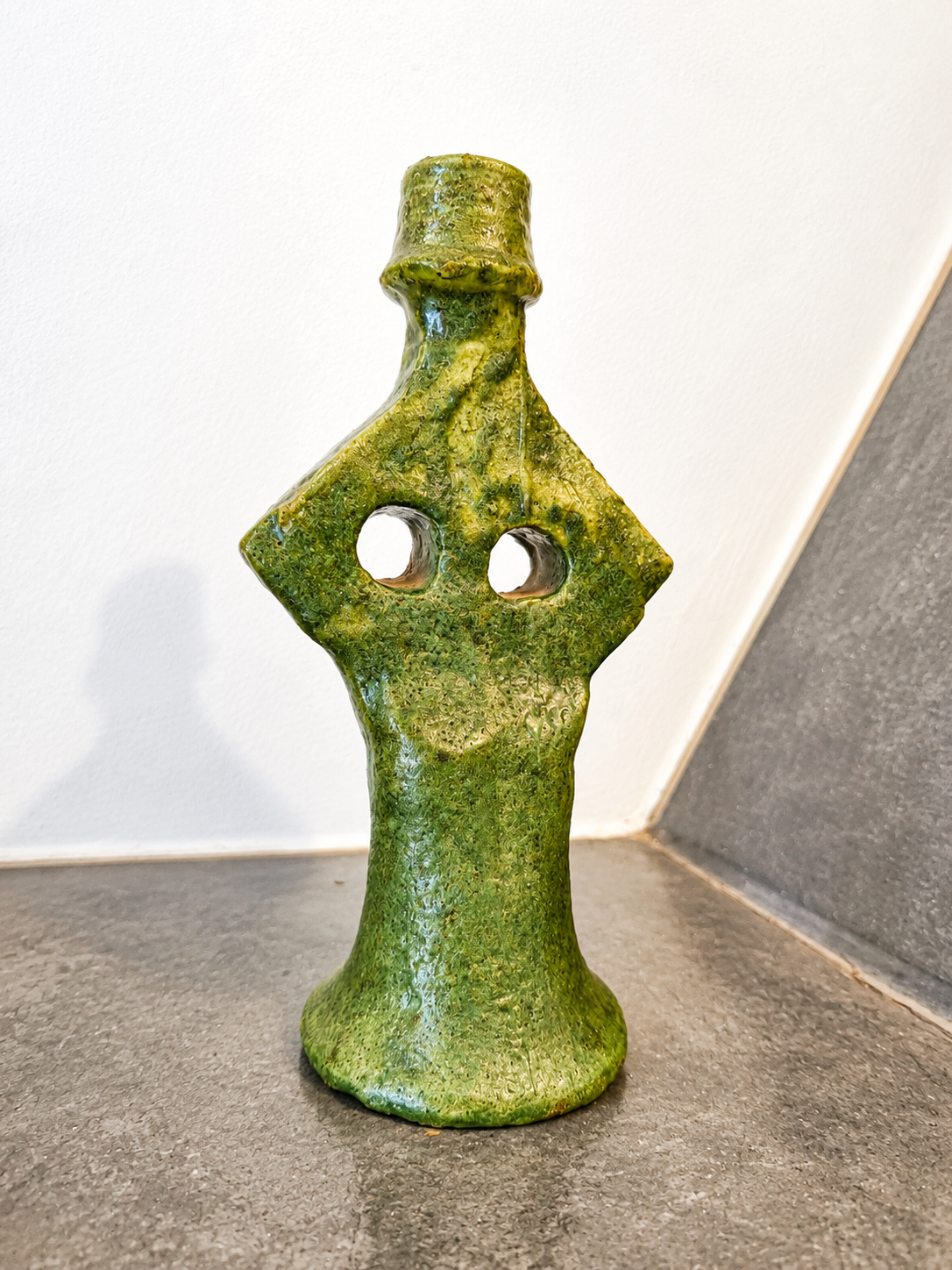 Back view of a handcrafted green Moroccan ceramic candle holder with traditional artisan craftsmanship.