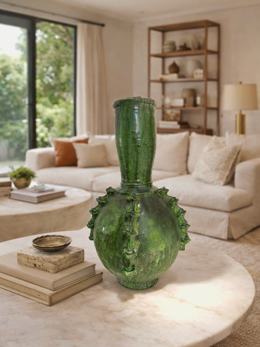 Handmade Tamegroute green ceramic vase displayed on a marble coffee table in a minimalist living room