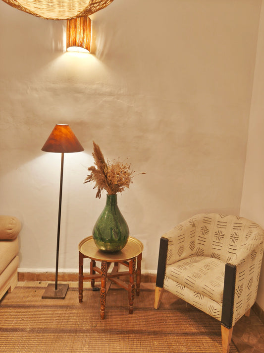 Handmade green Tamegroute vase filled with dried pamps and natural stems as boho Moroccan home decore .