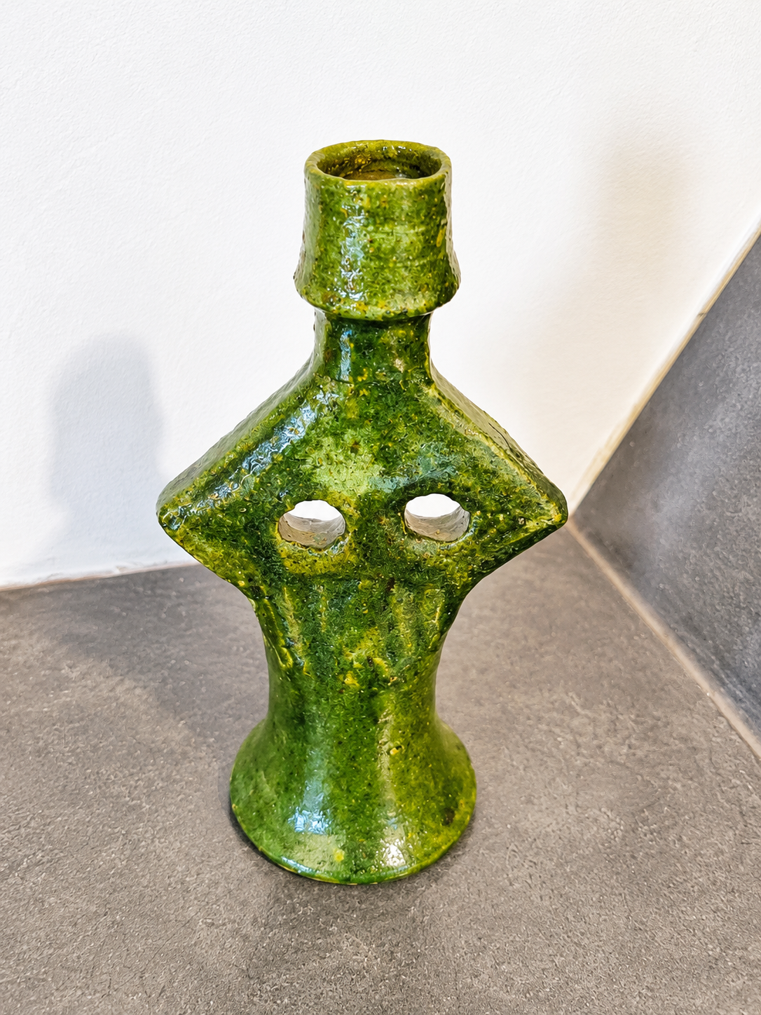 Angled view of a handmade green glazed Moroccan ceramic candle holder featuring an authentic artisan design.