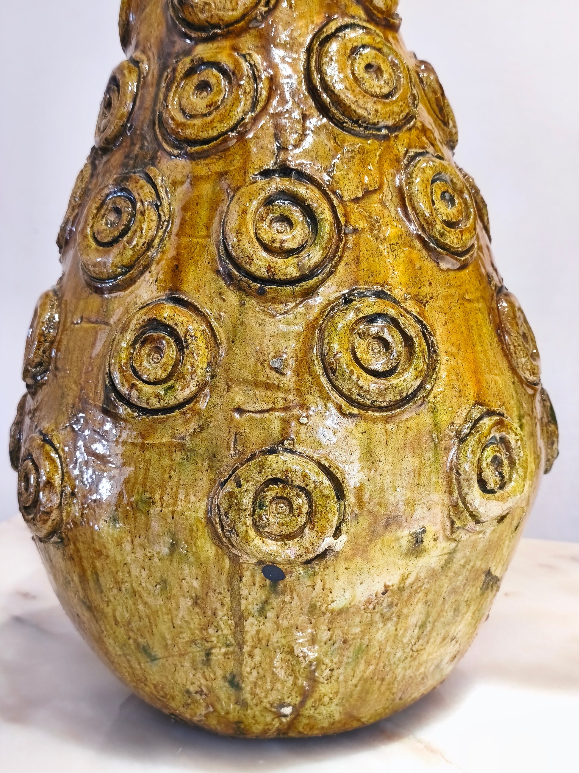 Decorative ceramic vase with spiral patterns on a white background